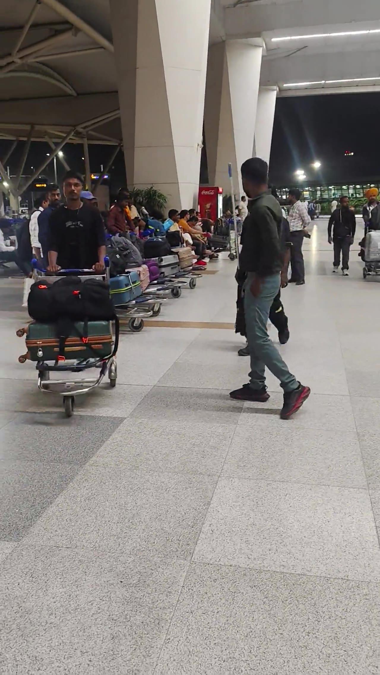 Candidates walking through the airport terminal with their luggage on departure night